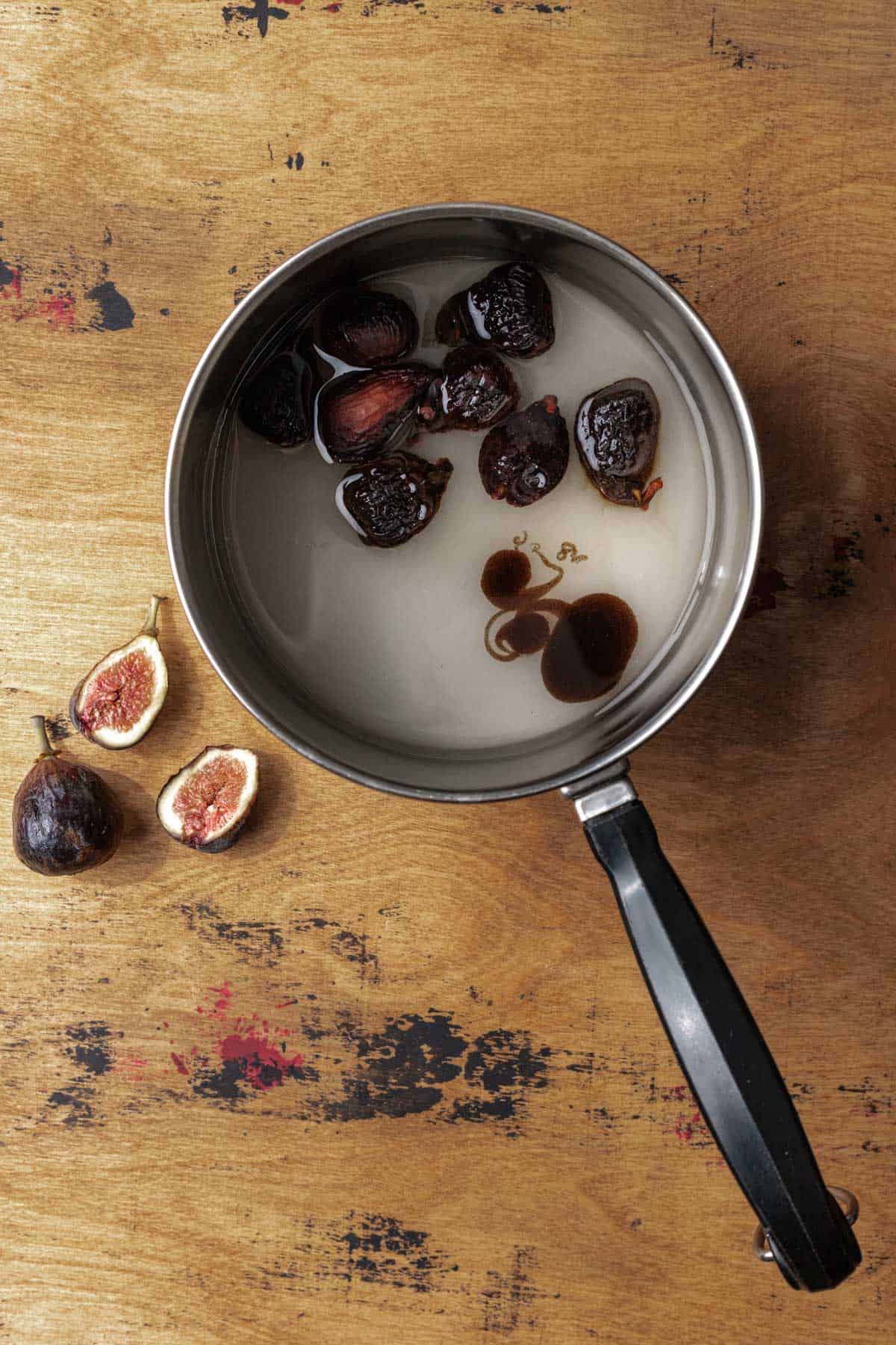 Dried figs, sugar, water, and vanilla paste in a saucepan.