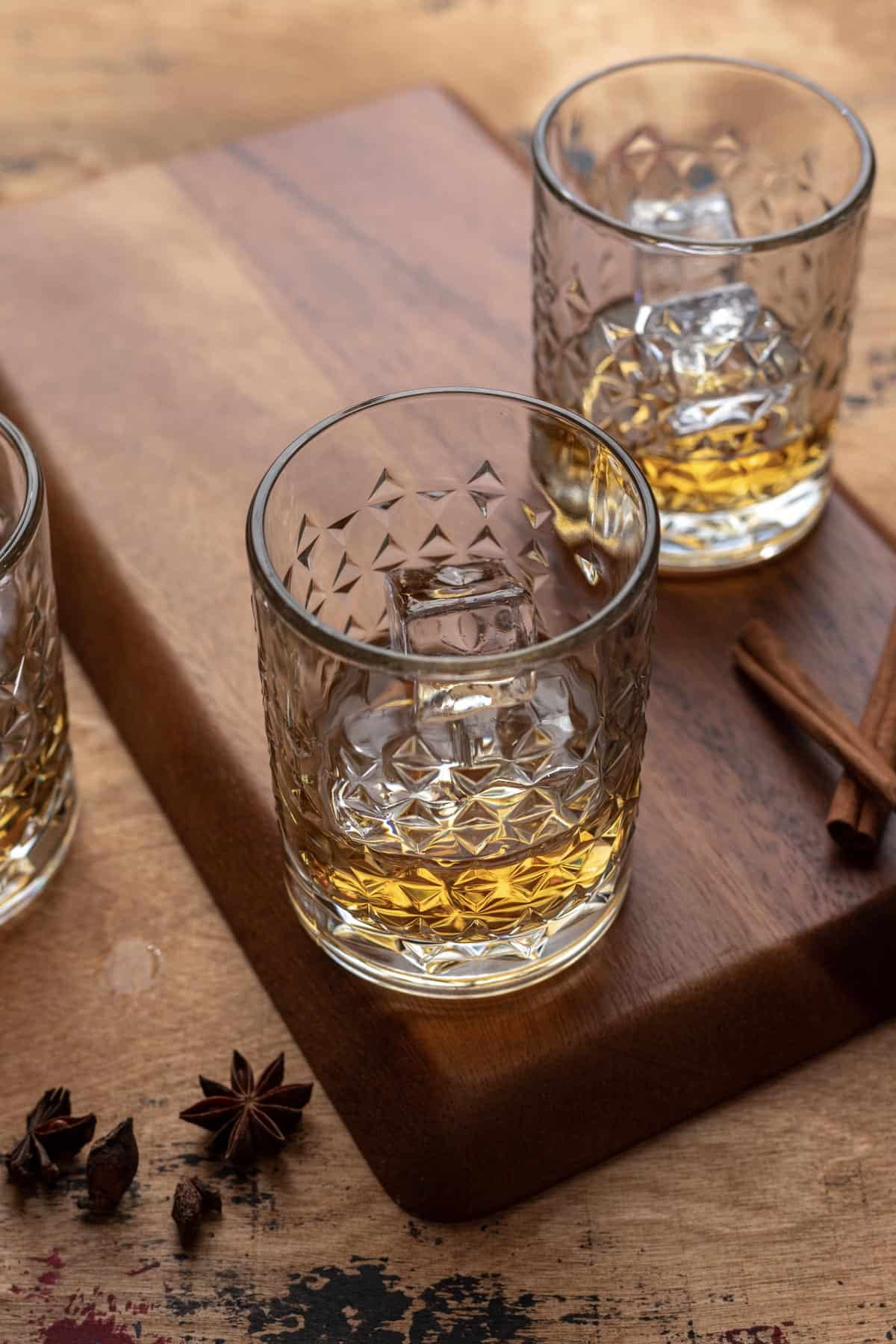 Bourbon poured into rocks glasses with ice.