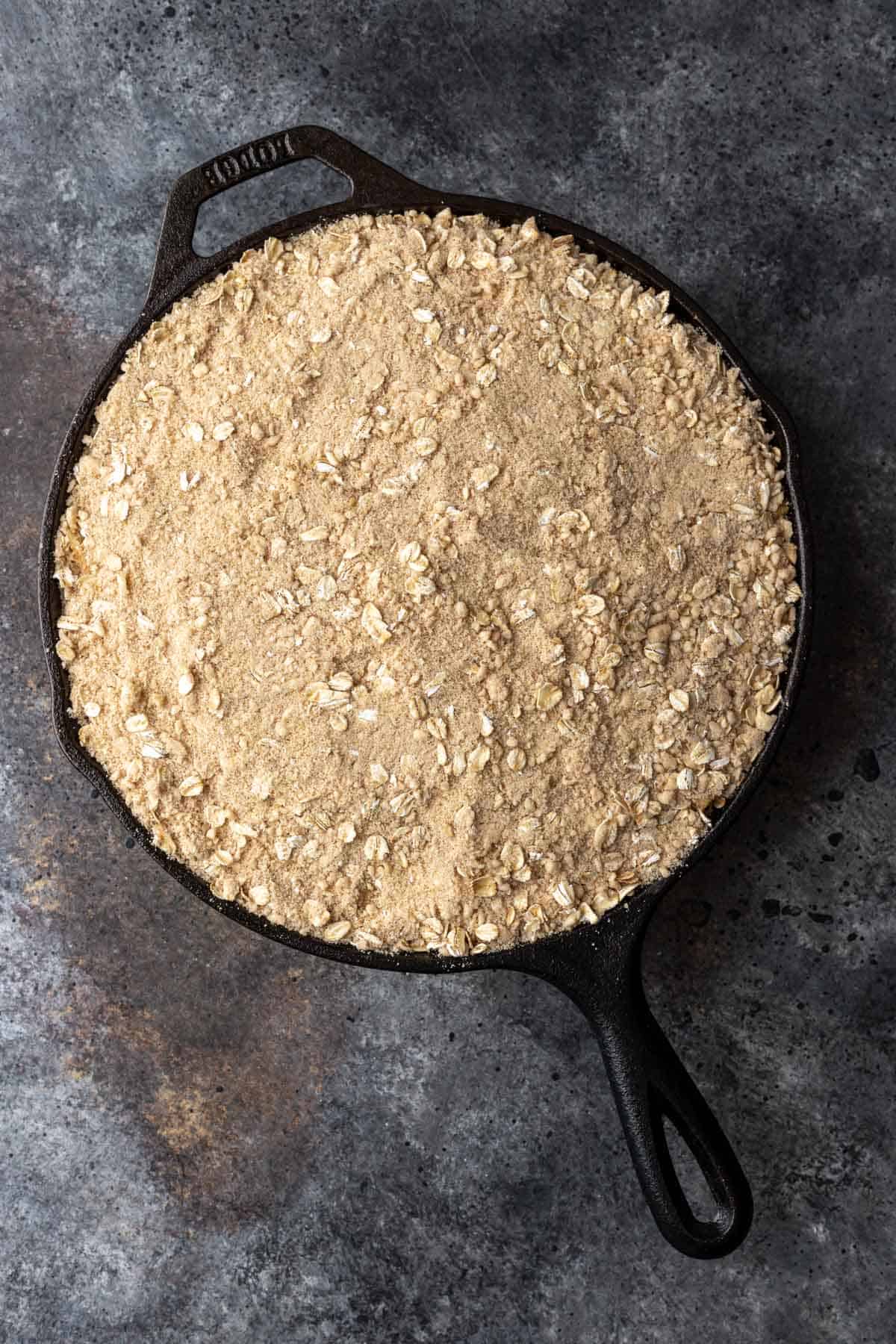 Diced apples topped with crisp oat topping before baking.