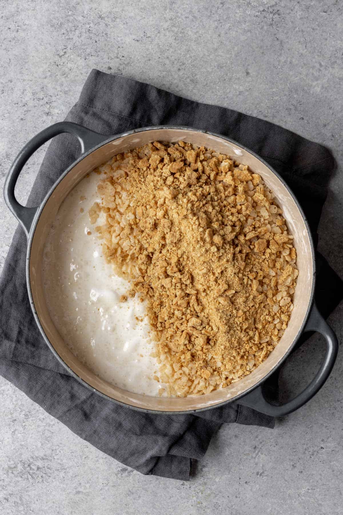 Melted marshmallows with rice cereal and crushed graham crackers on top.