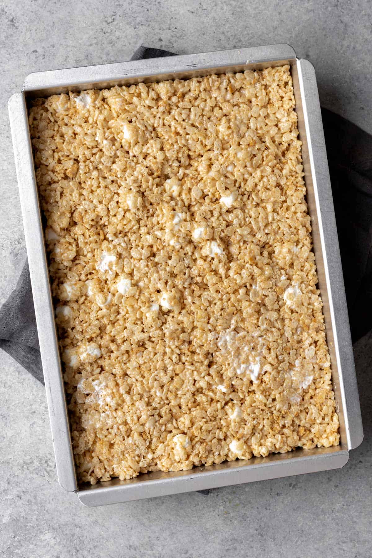 Smores rice krispie treats with marshmallows in a 9x13 baking pan.