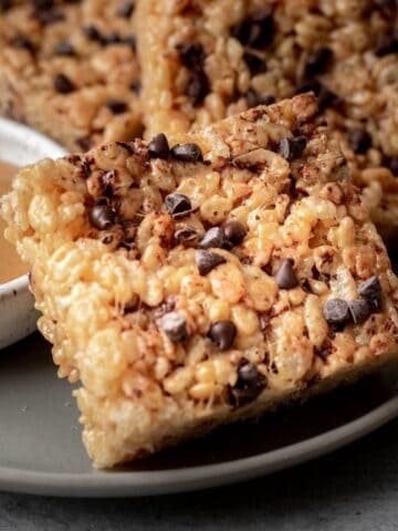 Peanut butter chocolate chip rice krispie treats on a gray plate.