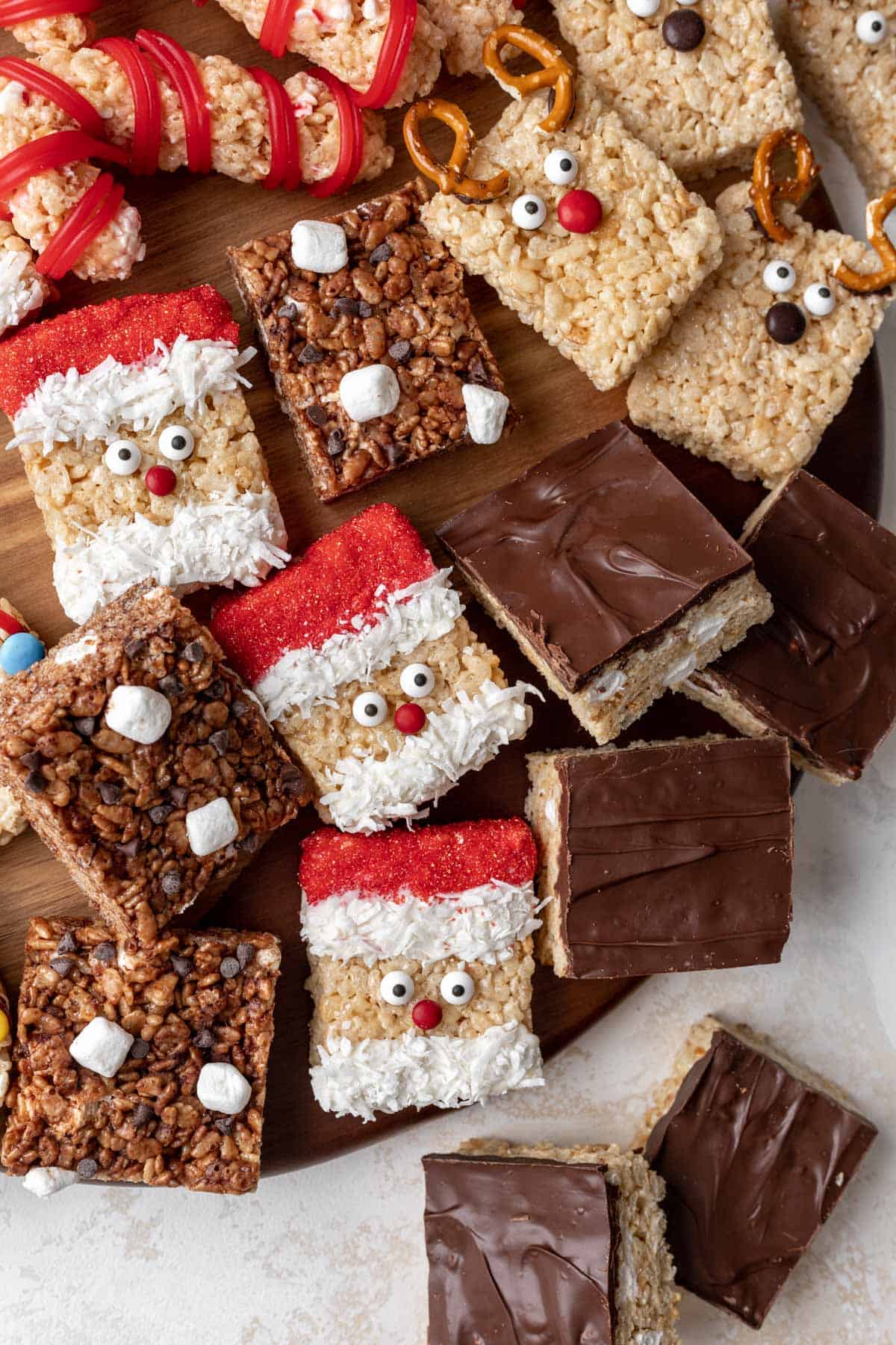 Hot chocolate, santa, reindeer, and smores rice krispie treats on a board.