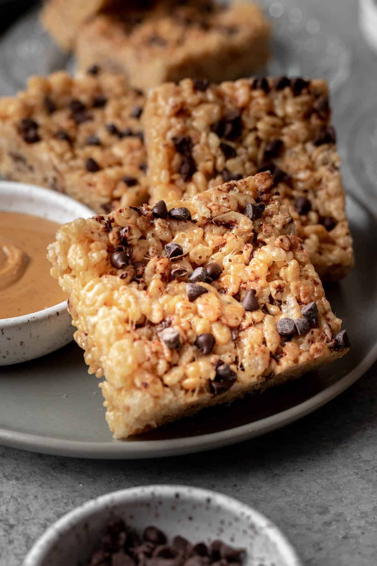 Peanut butter chocolate chip rice krispie treats on a gray plate.