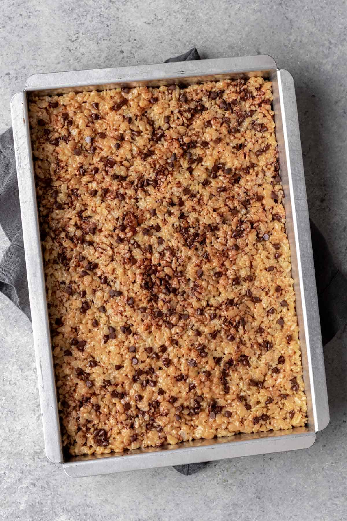 Peanut butter chocolate chip rice krispie treats in a 9x13 pan.