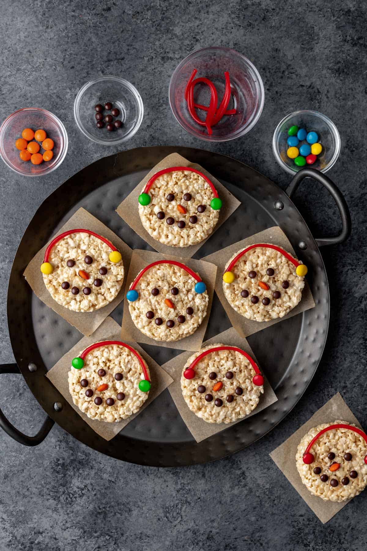 Snowman rice krispie treats with colorful candy earmuffs.