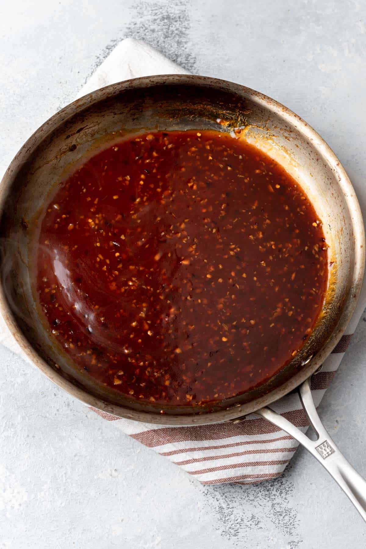 Thickened general tso's sauce in a skillet.