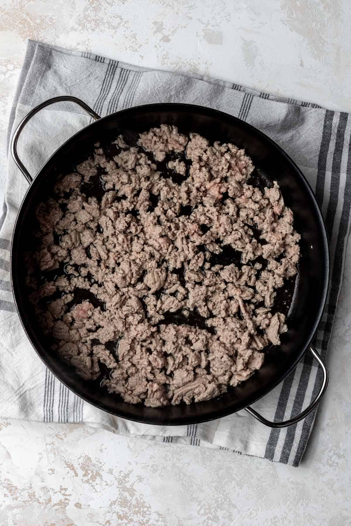 Cooked ground turkey in a large skillet.