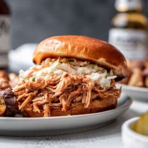 Instant pot bbq shredded chicken on a bun with coleslaw.