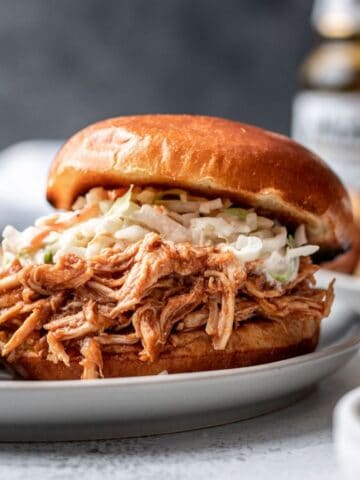 Instant pot bbq shredded chicken on a bun with coleslaw.