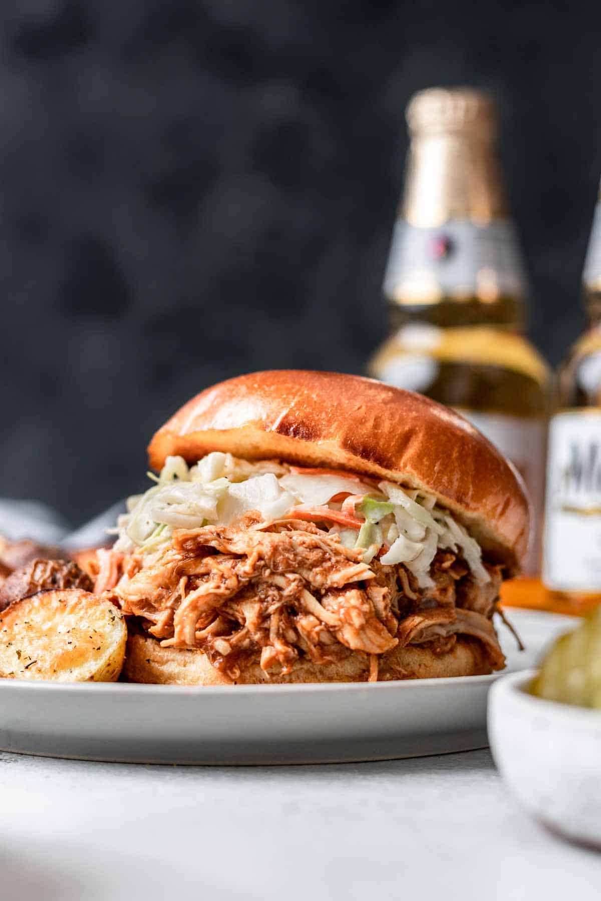 Instant pot bbq shredded chicken on a bun with coleslaw.