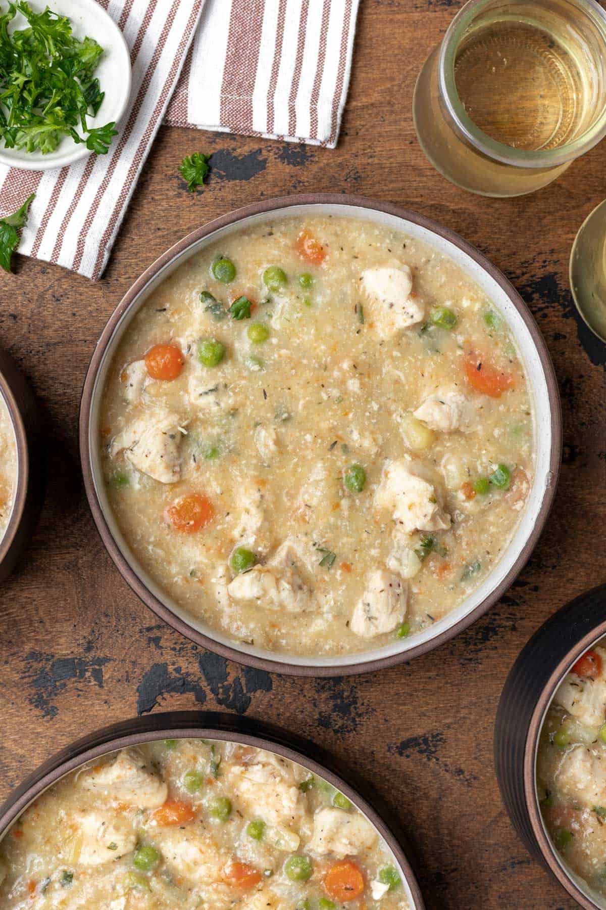 Thickened chicken pot pie filling in a soup bowl.