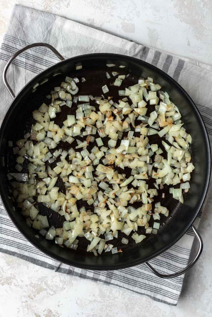 Onions sautéed in a skillet.