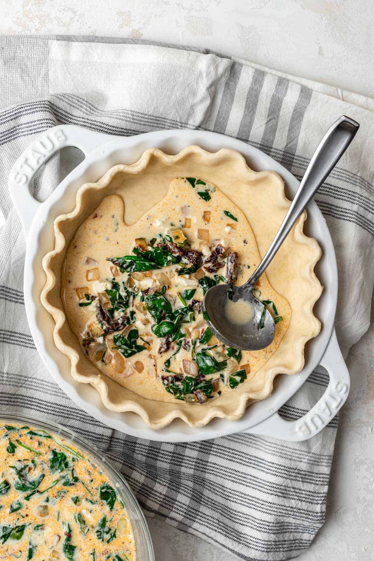 Mediterranean sun-dried tomato filling scooped into a quiche crust.