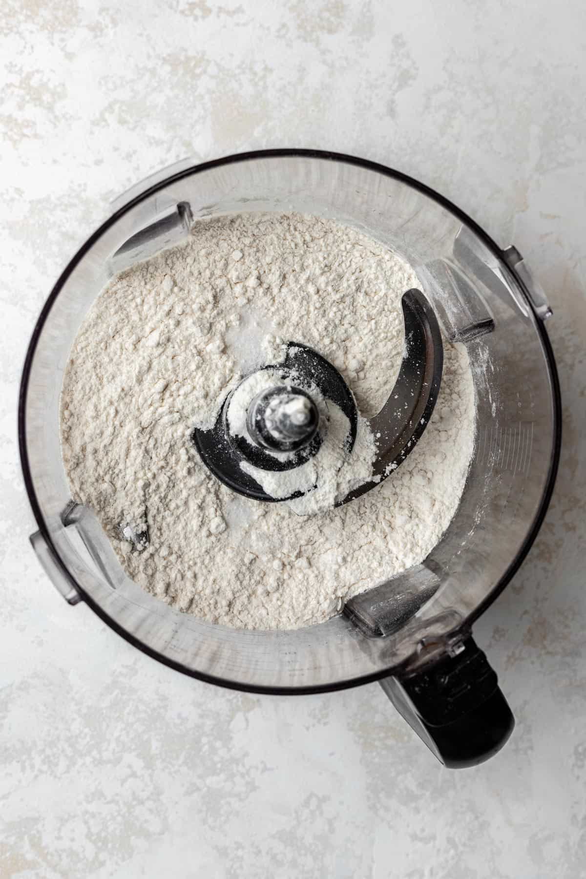 Flour and salt combined in a food processor.