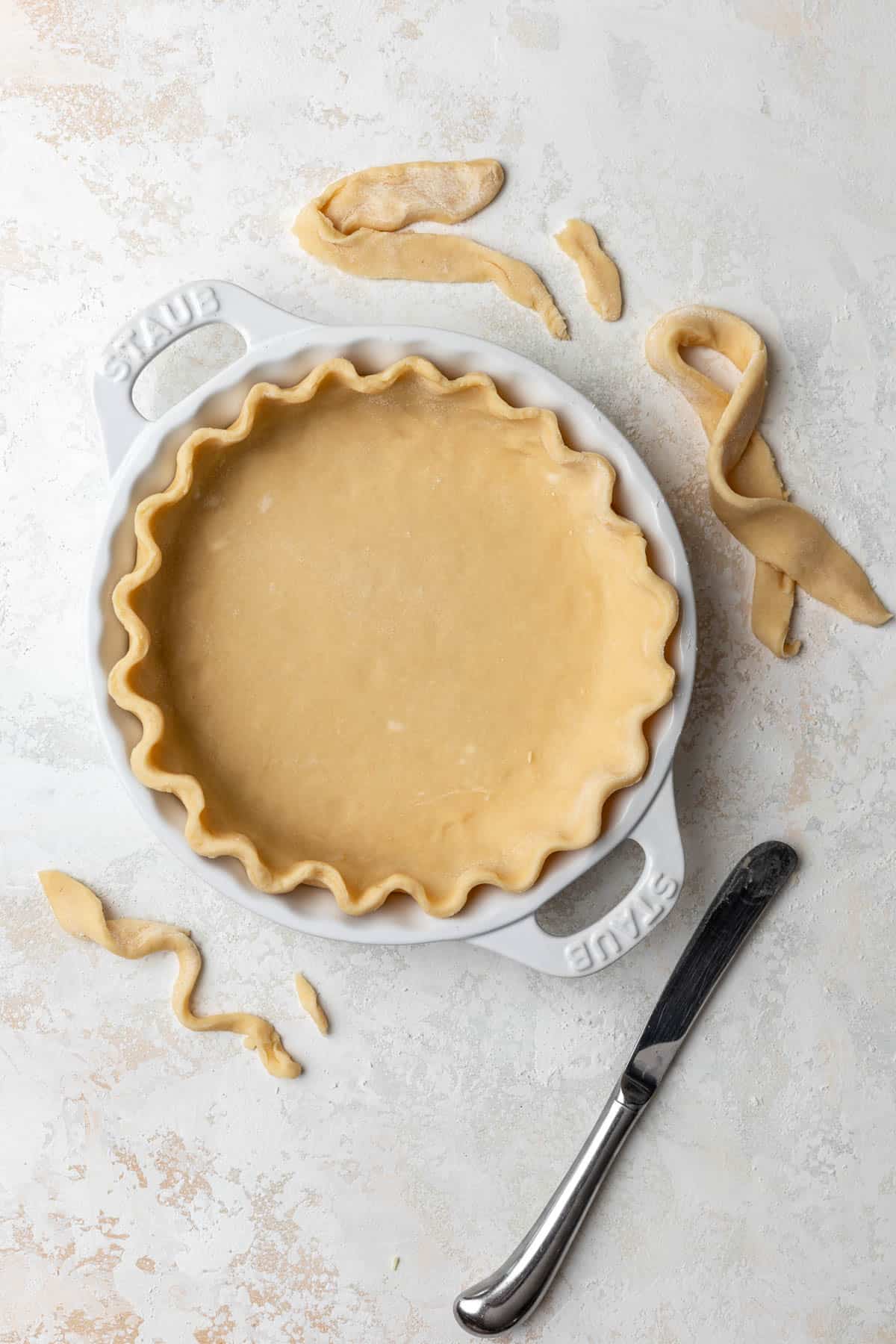 Quiche crust crimped in a pie pan.