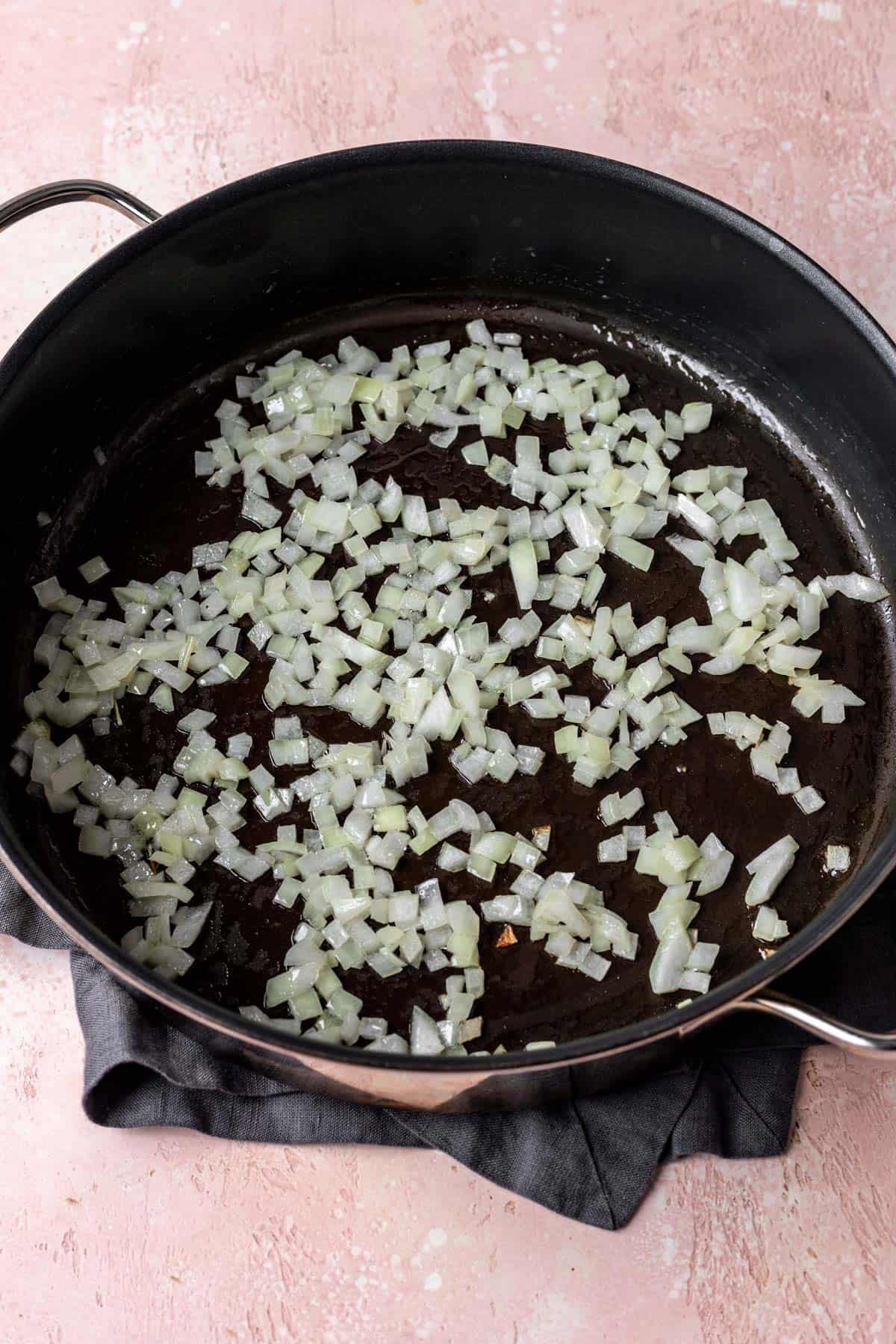 Onions sautéing in a large skillet.