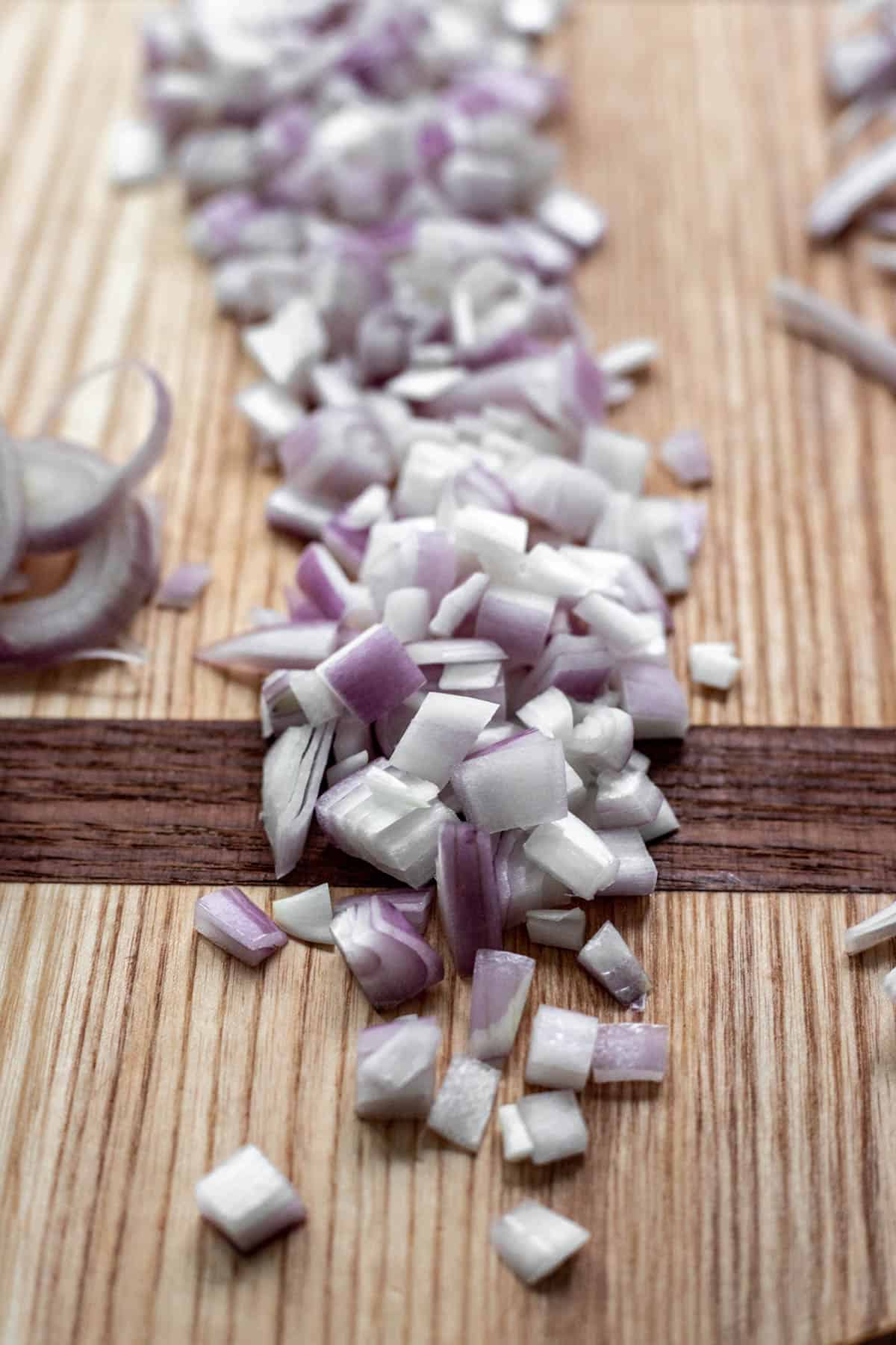 Diced shallot on a cutting board.