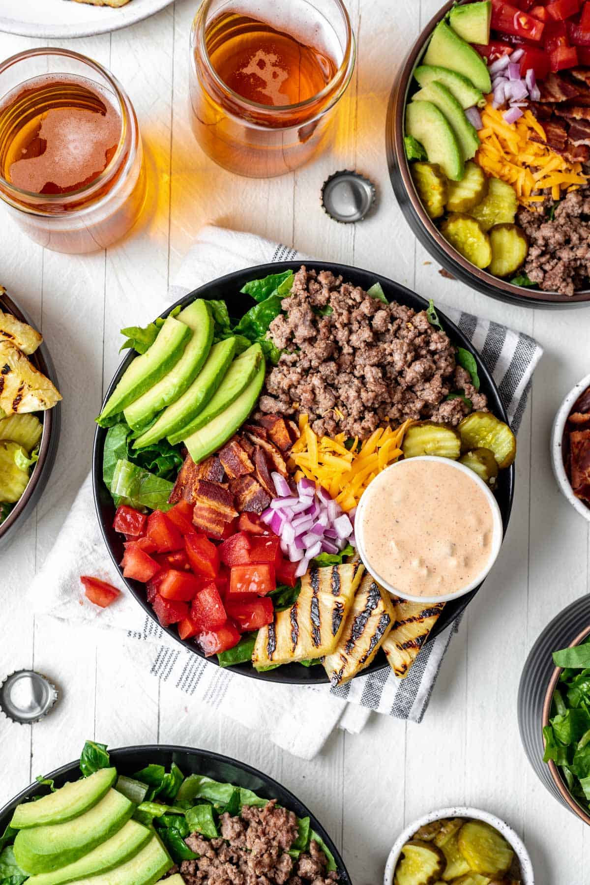 Burger bowls loaded with toppings and a side of homemade burger sauce.