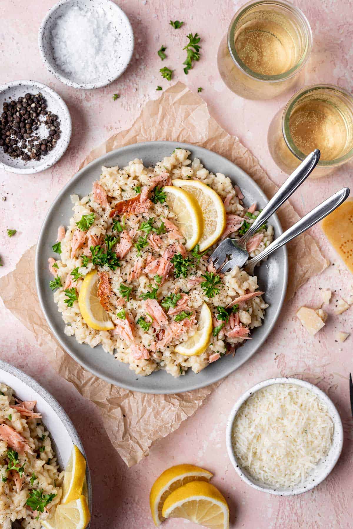 A serving of smoked salmon risotto on a gray plate with two forks.