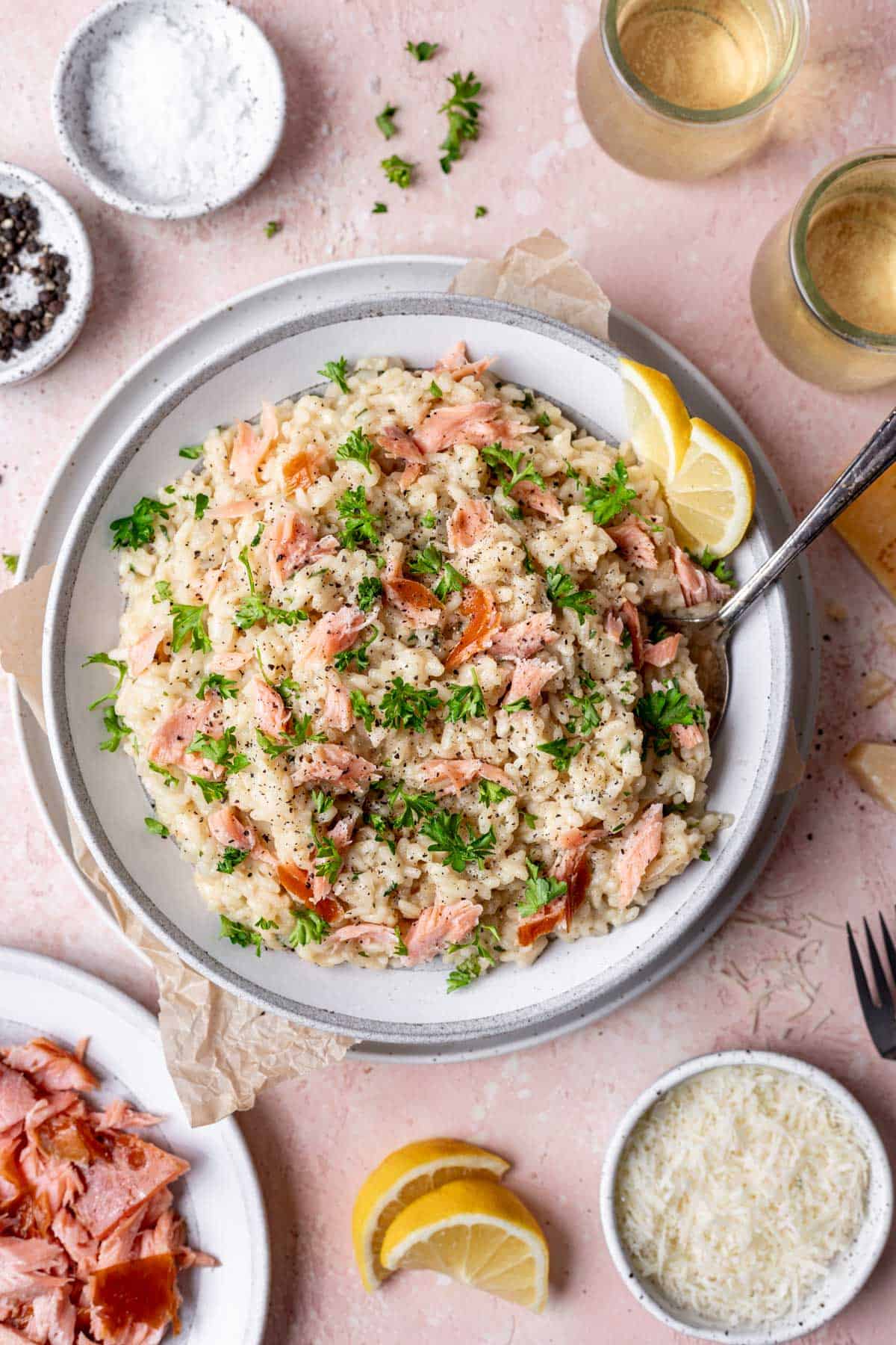 A large bowl of smoked salmon risotto garnished with lemon and parsley.