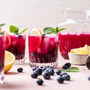 Blueberry vodka lemonade garnished with mint, blueberries, and a lemon slice.
