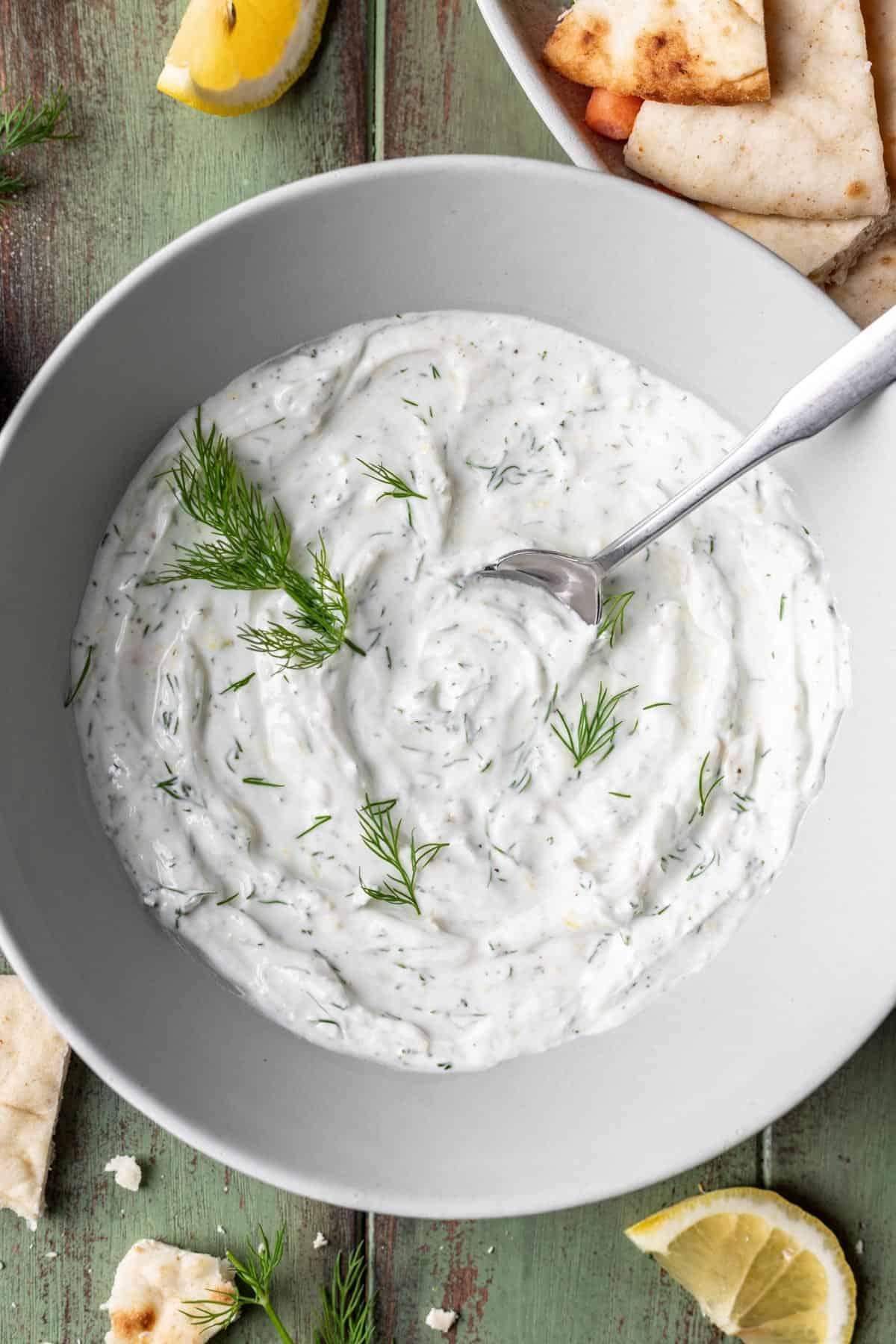 Lemon dill yogurt sauce garnished with fresh dill.