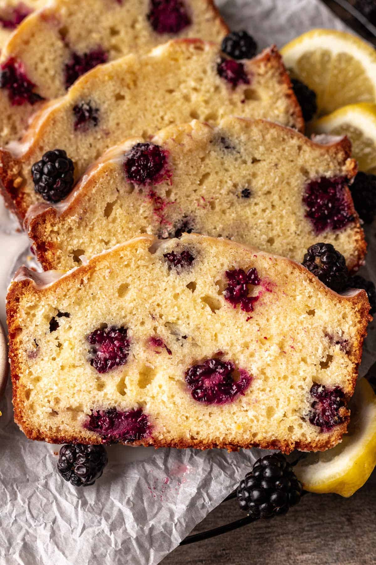 4 slices of blackberry lemon bread stacked on top of each other to show their center.