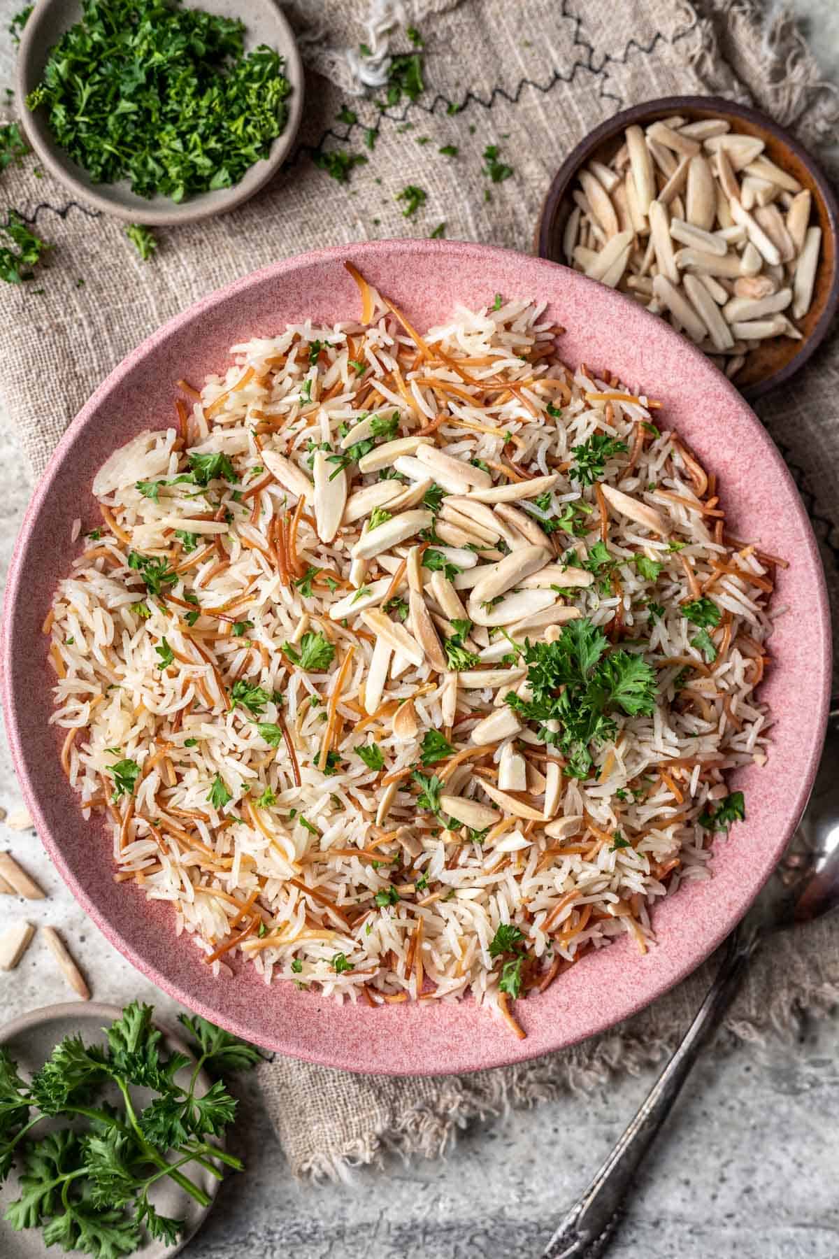 Instant pot rice pilaf in a serving bowl with fresh parsley.