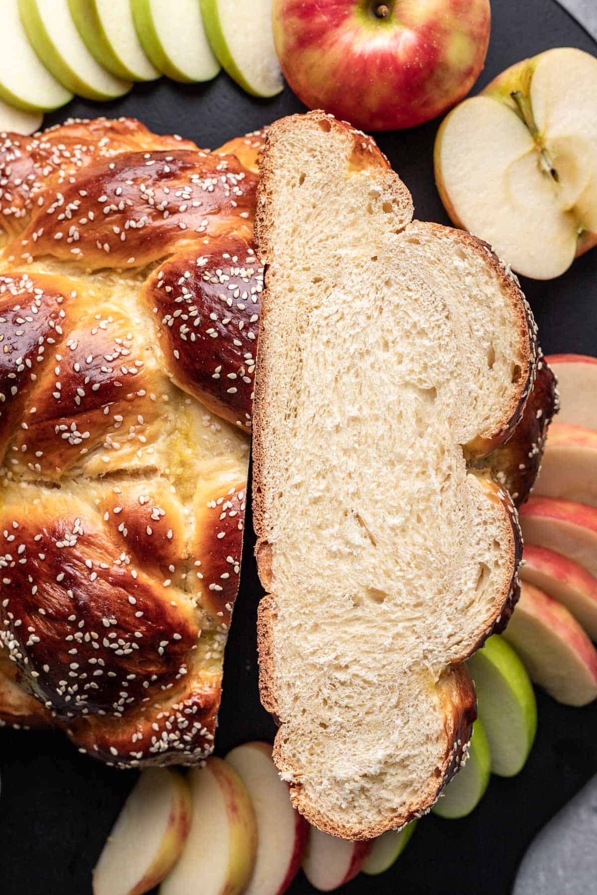 Round challah cut in half to show the top and the middle of the challah.