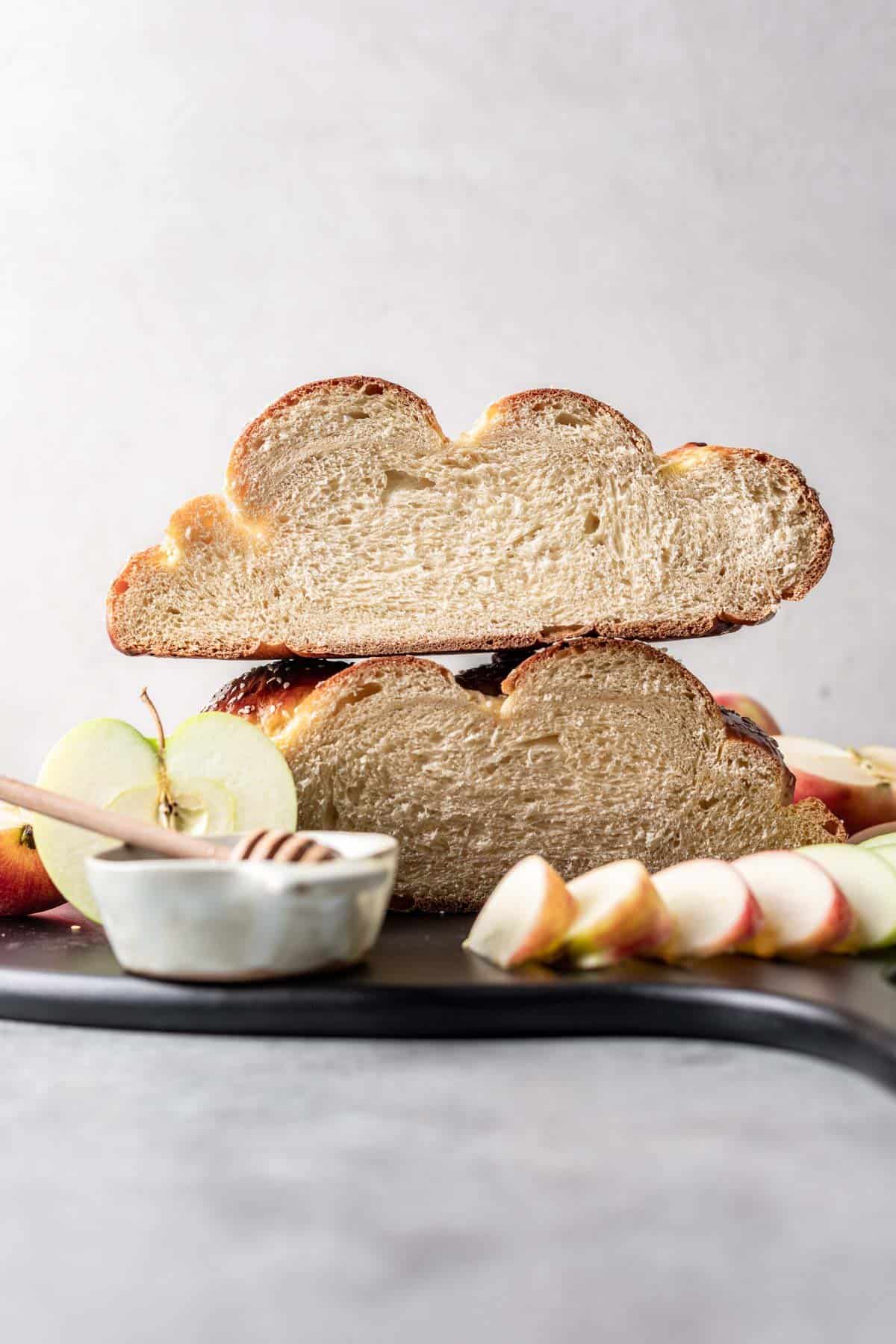 A round challah cut in half to show the texture in the middle.