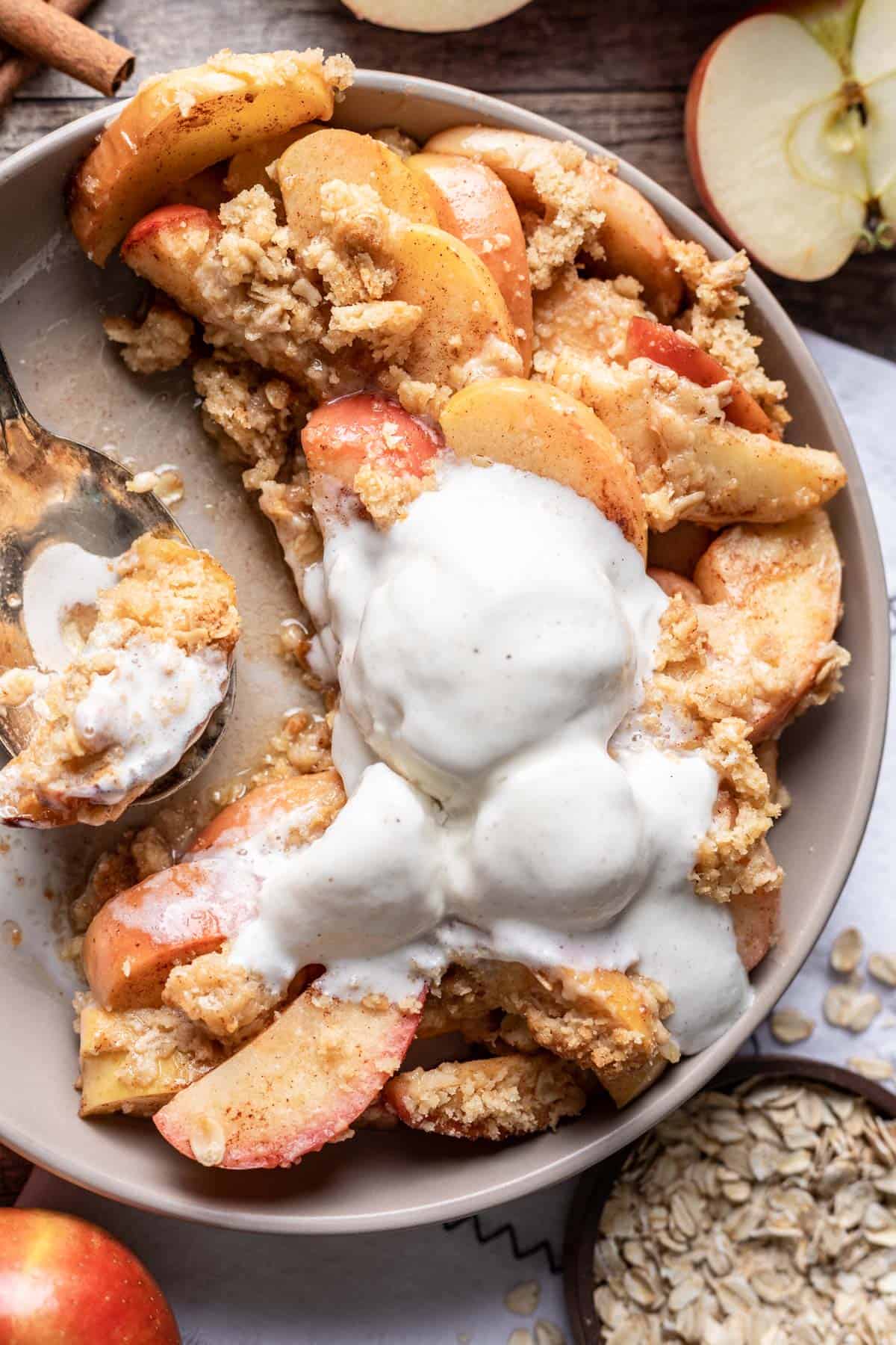 Air fryer apples in a serving bowl with a large serving spoon.