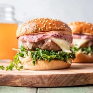 Apple turkey burger on a wood cutting board.