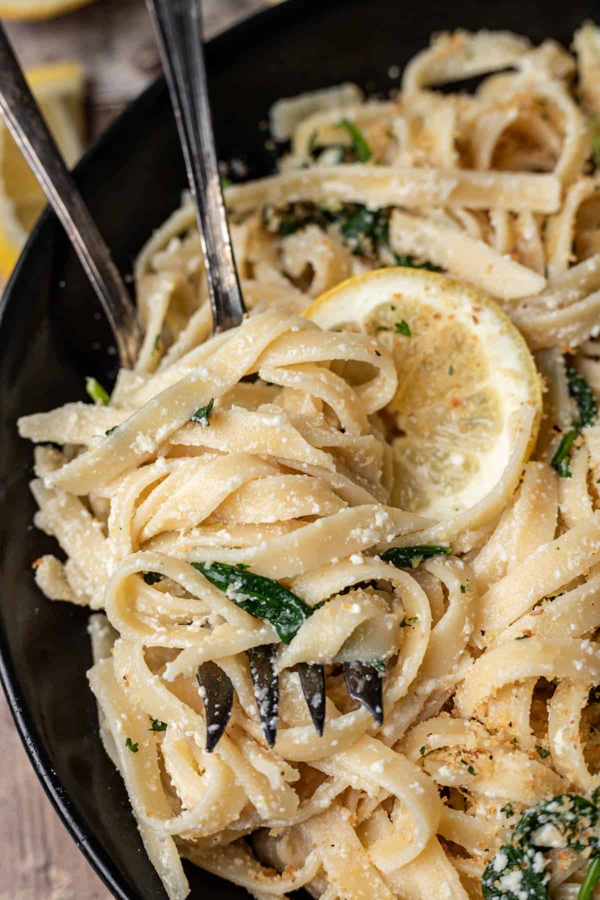 Lemon ricotta pasta twisted around two serving forks.