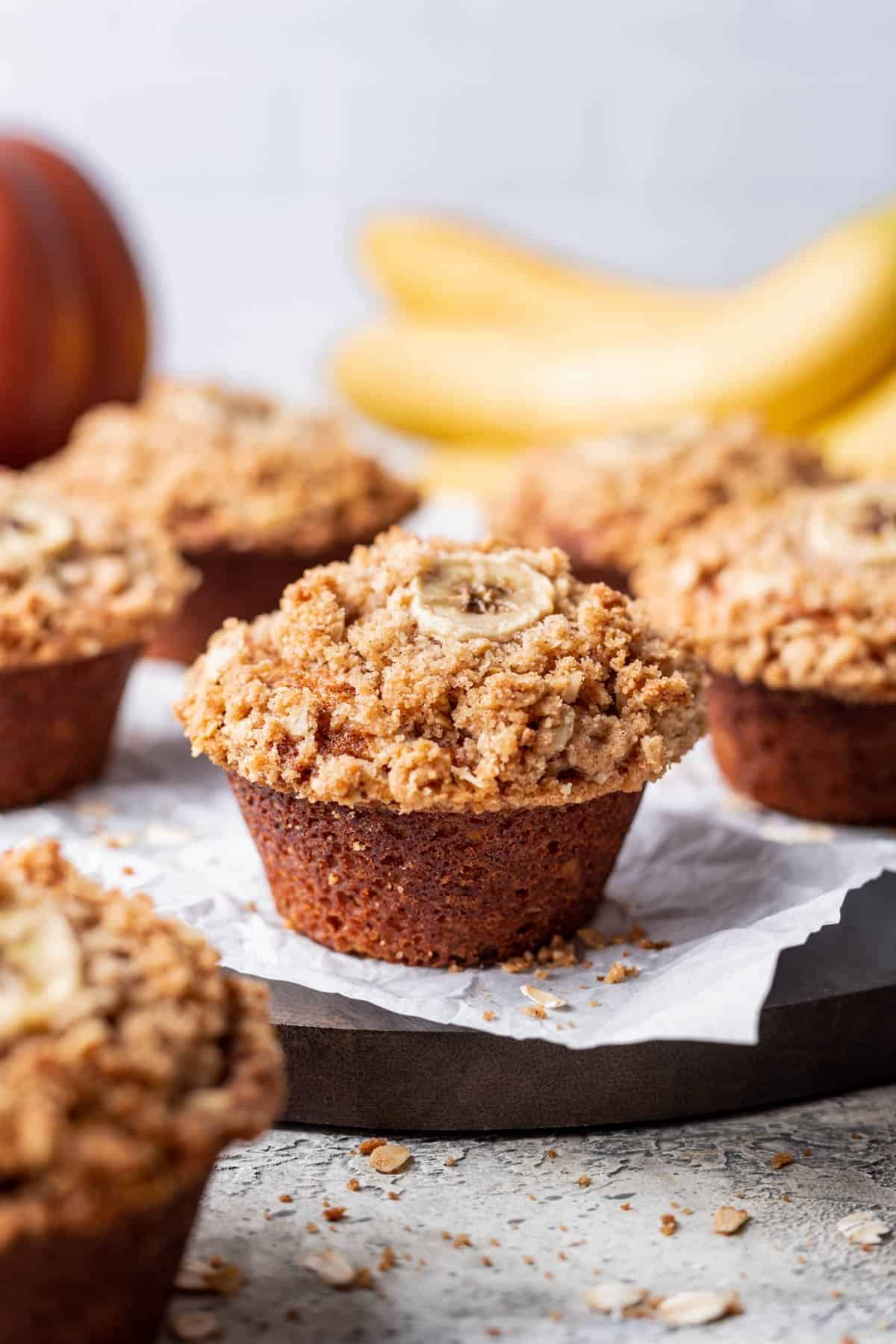 Pumpkin banana muffins with an oat crumble on a serving tray.