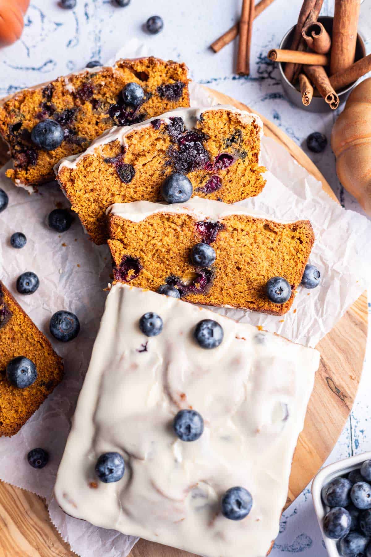 Pumpkin blueberry bread glazed and sliced into serving pieces.
