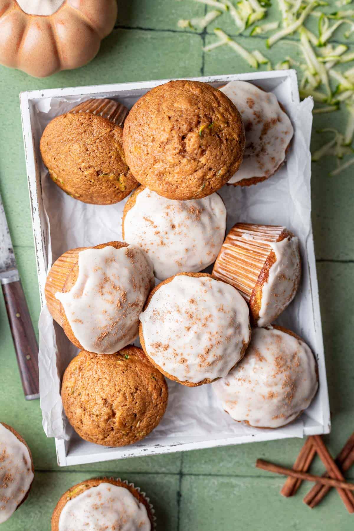 Glazed pumpkin zucchini muffins in a serving basket.