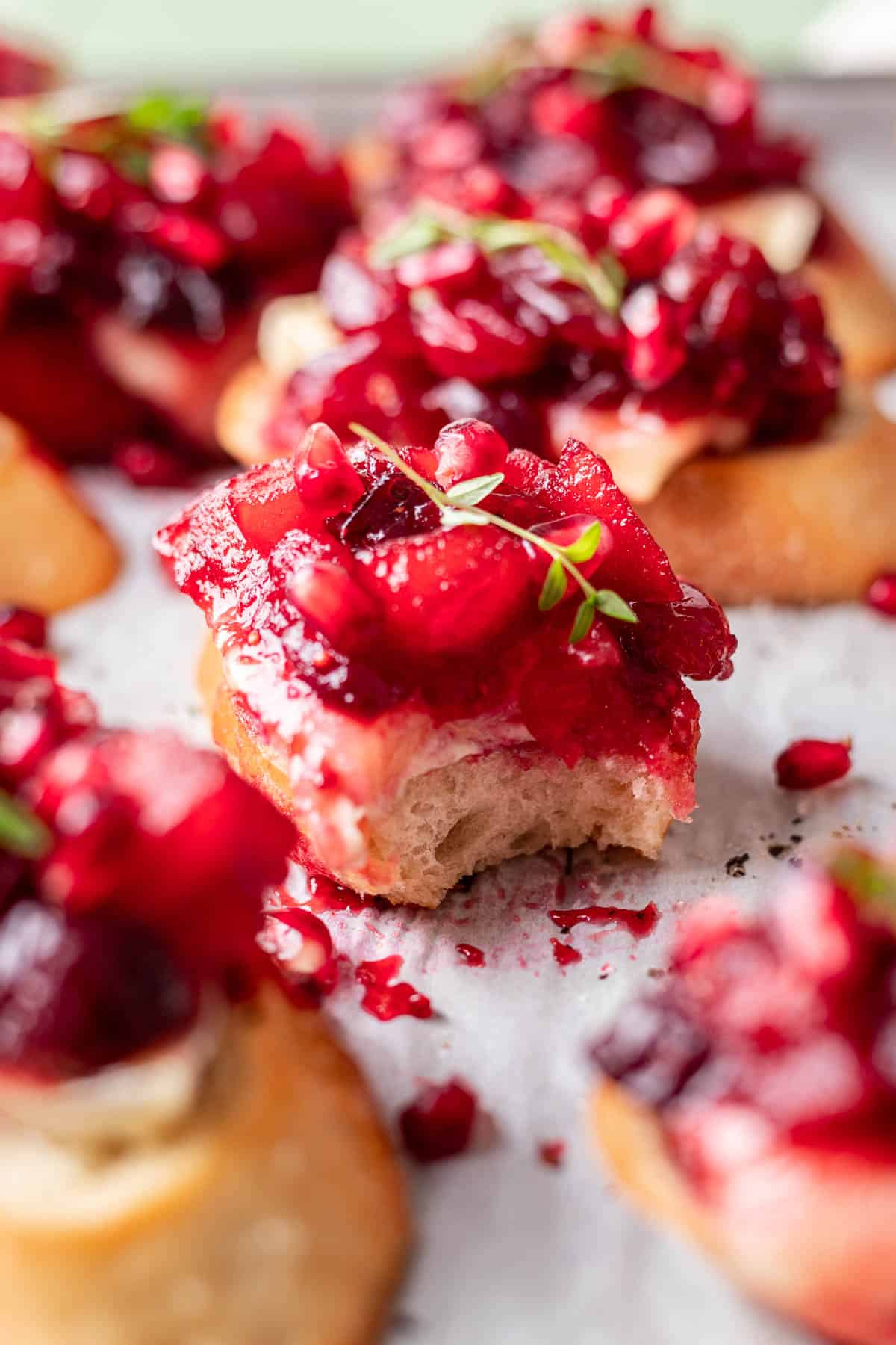 Cranberry brie crostini with a bite taken out to show the layers.