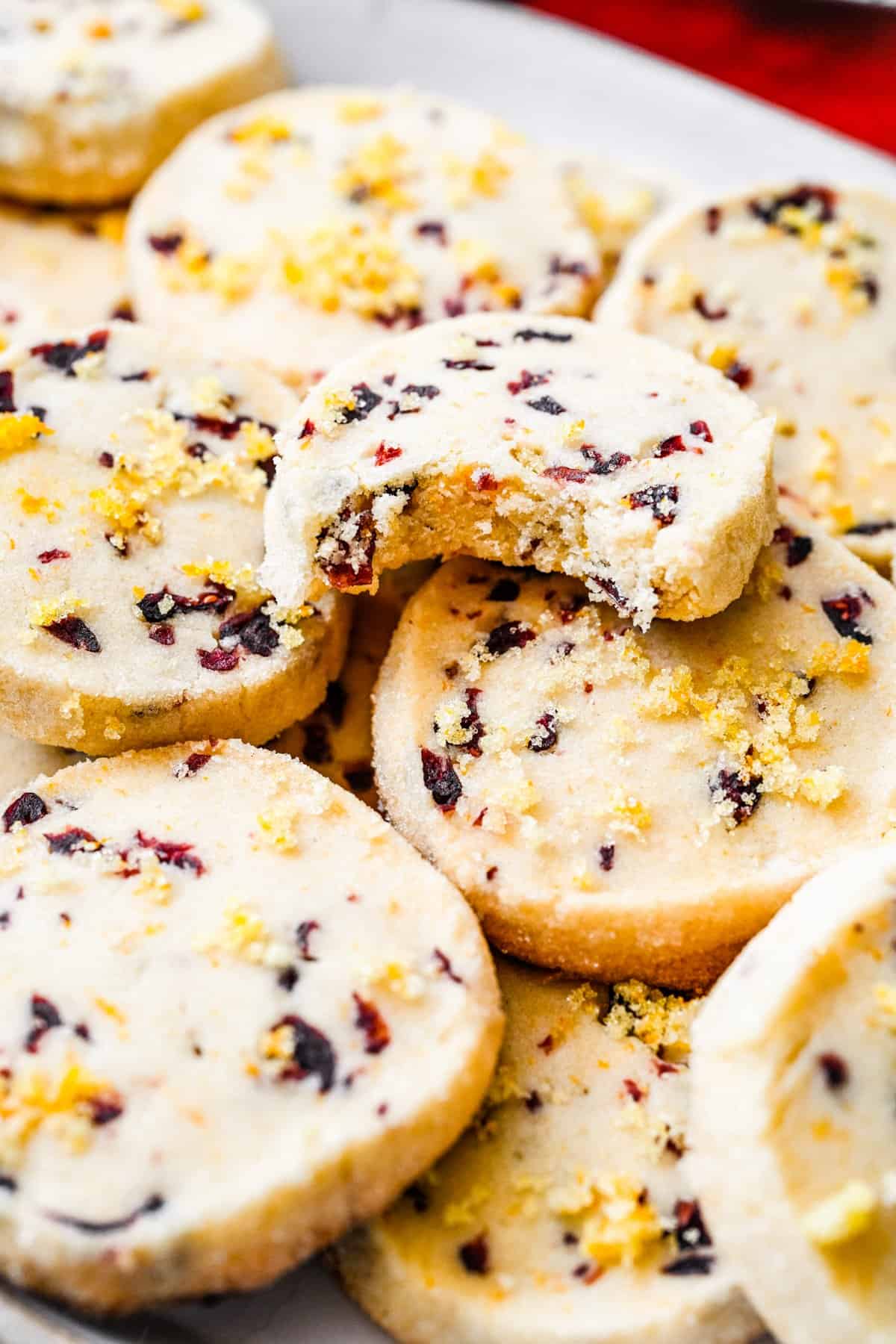 Cranberry shortbread cookies with a bite taken out.