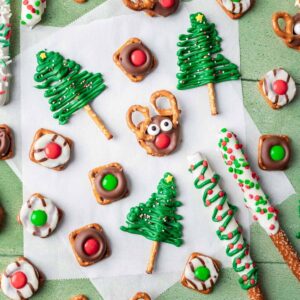 5 different christmas pretzels on a green and white backdrop.