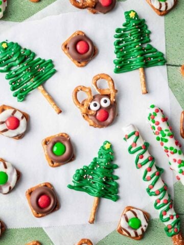 5 different christmas pretzels on a green and white backdrop.