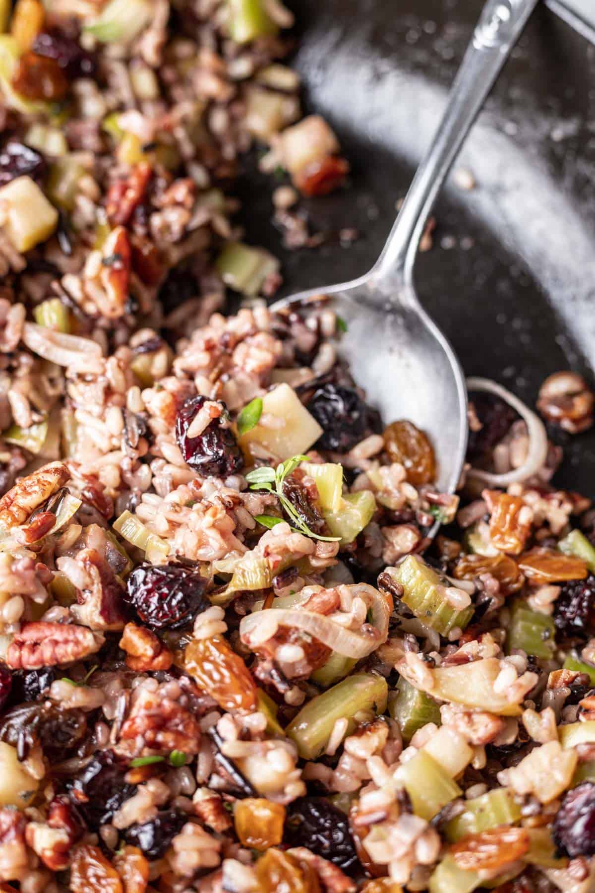 Wild rice for thanksgiving scooped by a serving spoon.