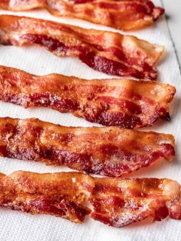 Instant pot bacon on a paper towel lined plate.