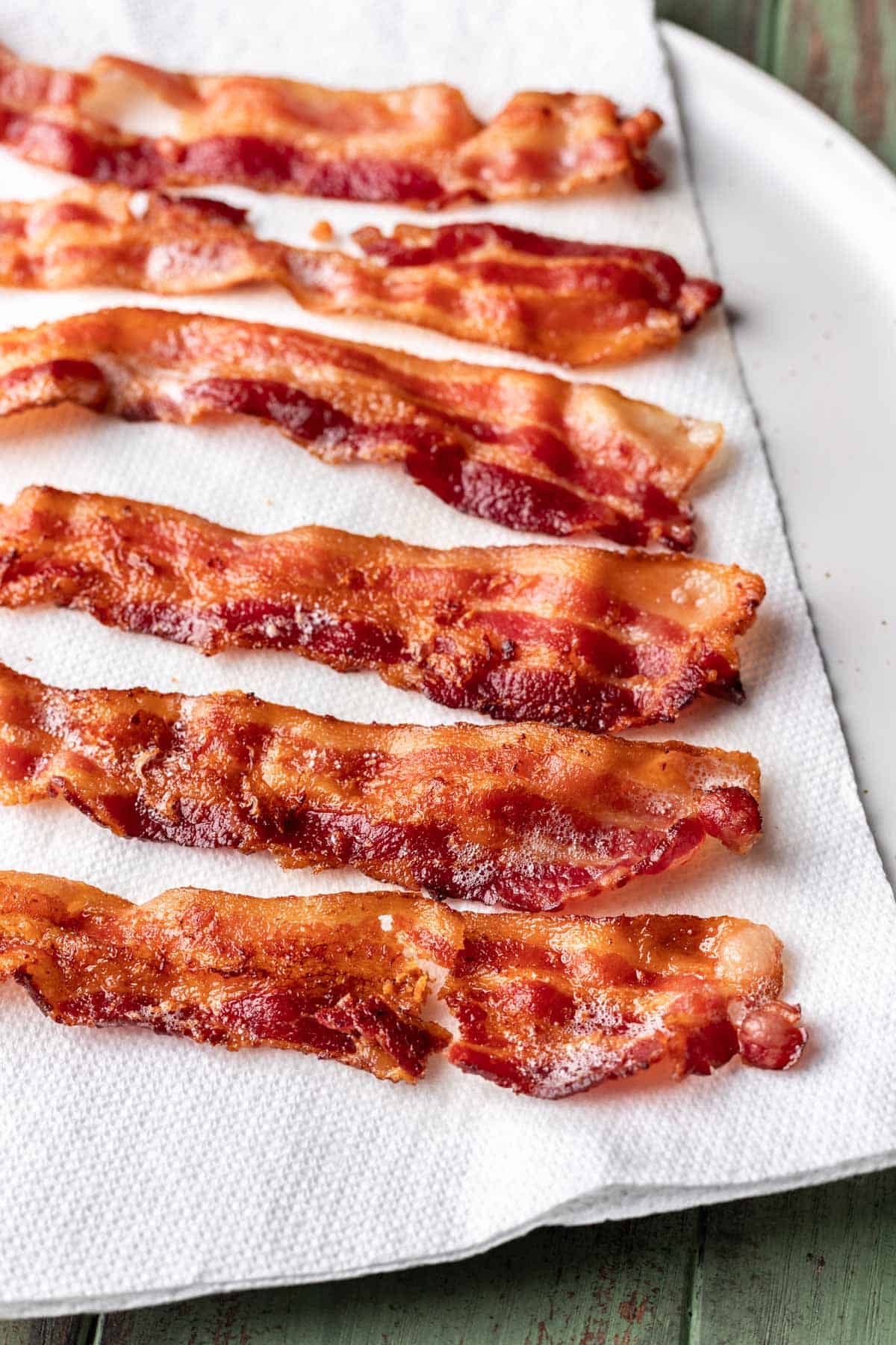 Instant pot bacon on a paper towel lined plate.