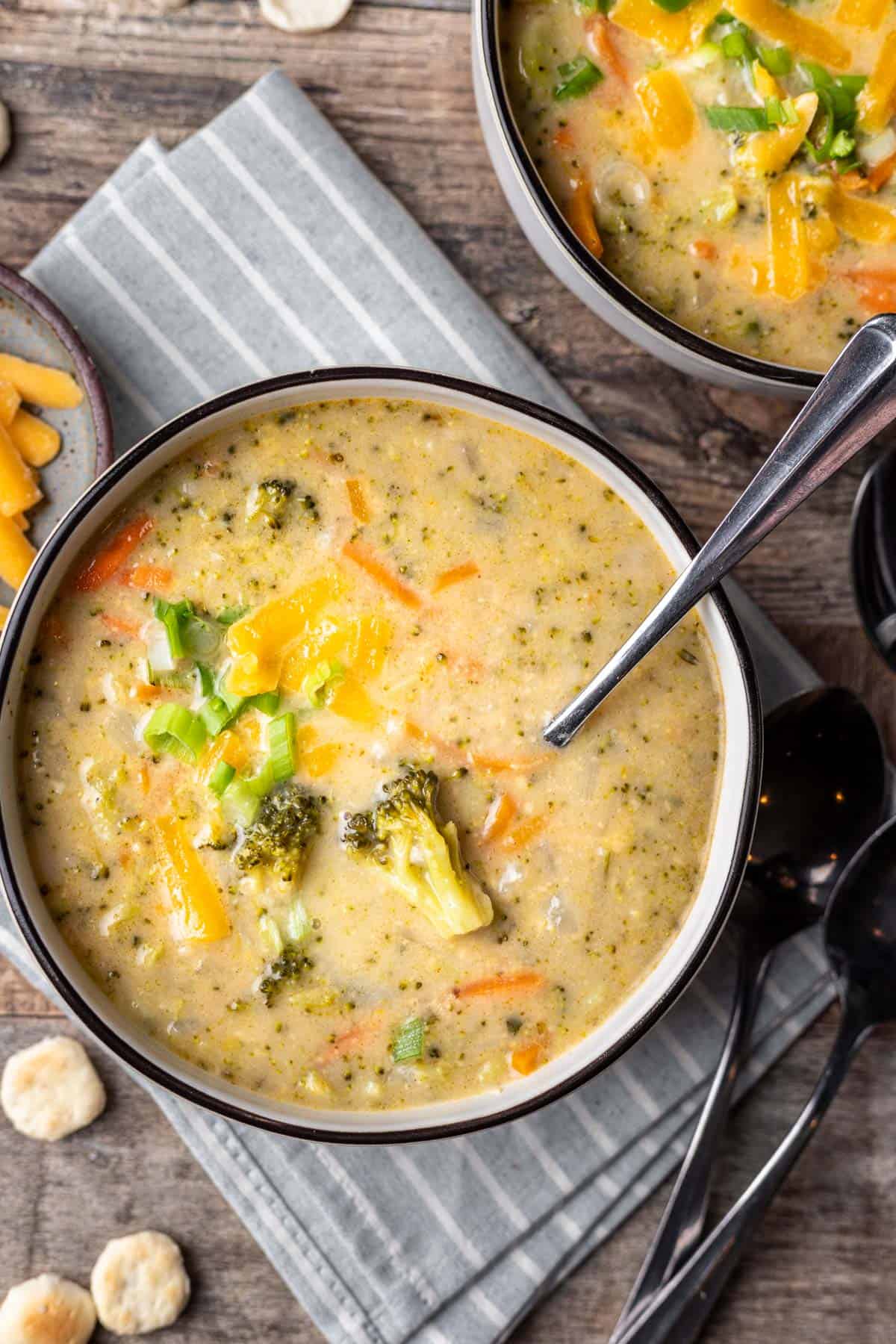 Instant pot broccoli cheddar soup in a bowl with a spoon.