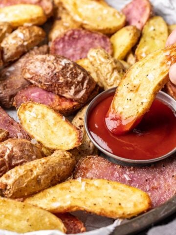 Air fryer fingerling potato dipped in ketchup.