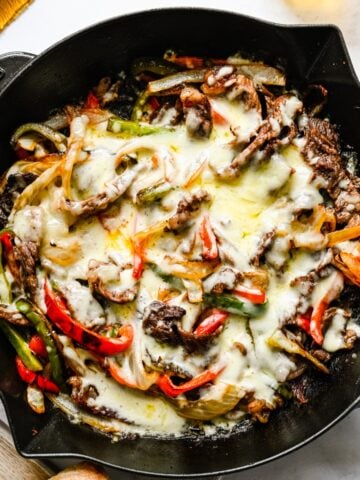 Philly cheesesteak skillet on a white background.