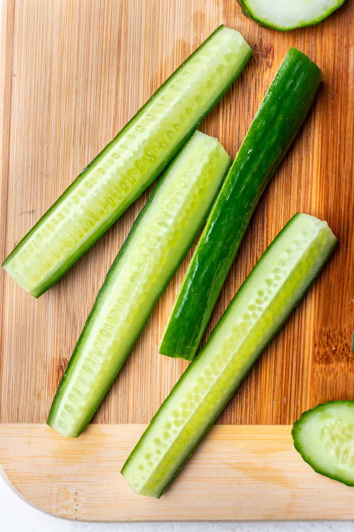 Cucumber strips on a cutting board.