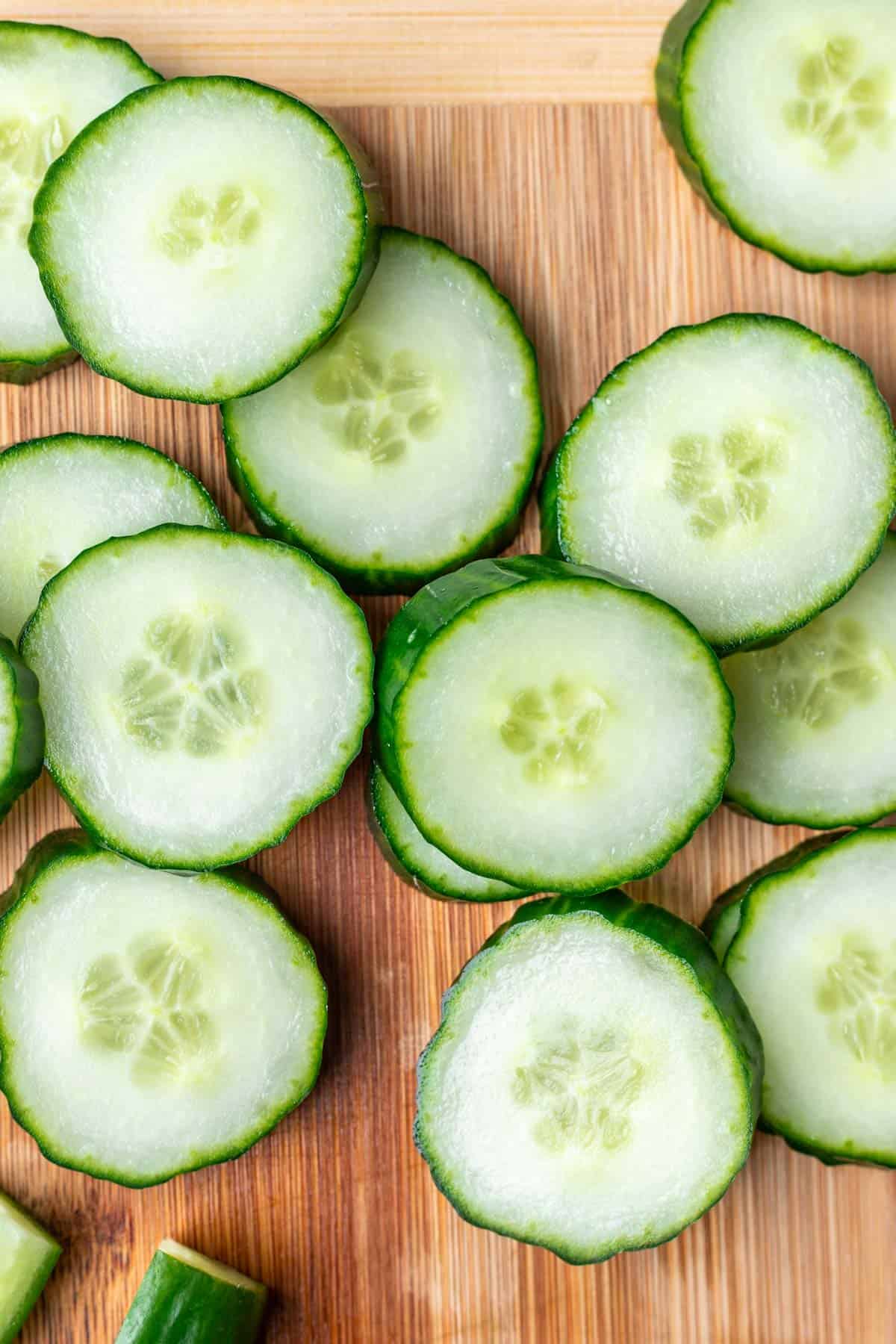 Sliced cucumbers on a cutting board.