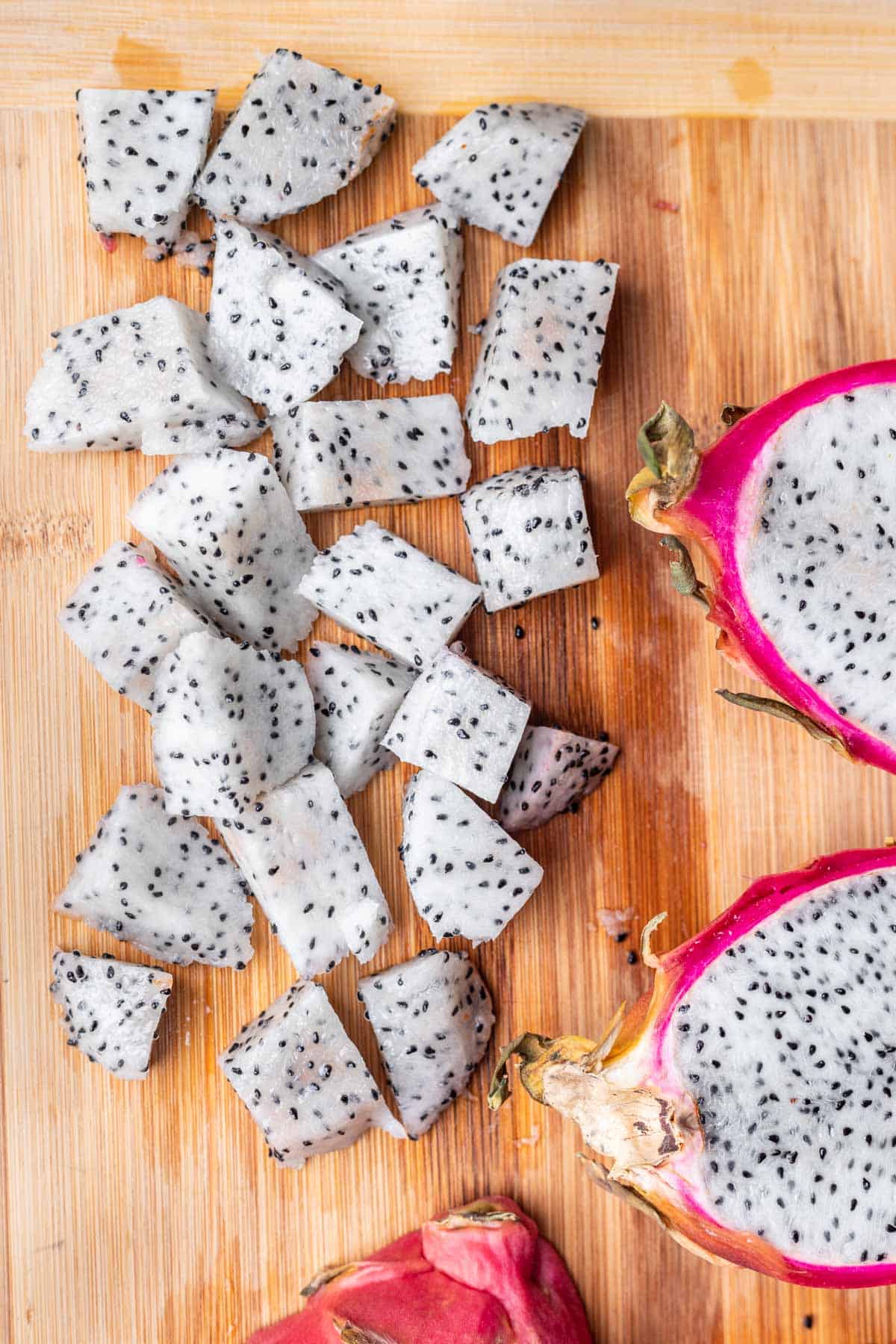 Pieces of diced dragon fruit on a cutting board.